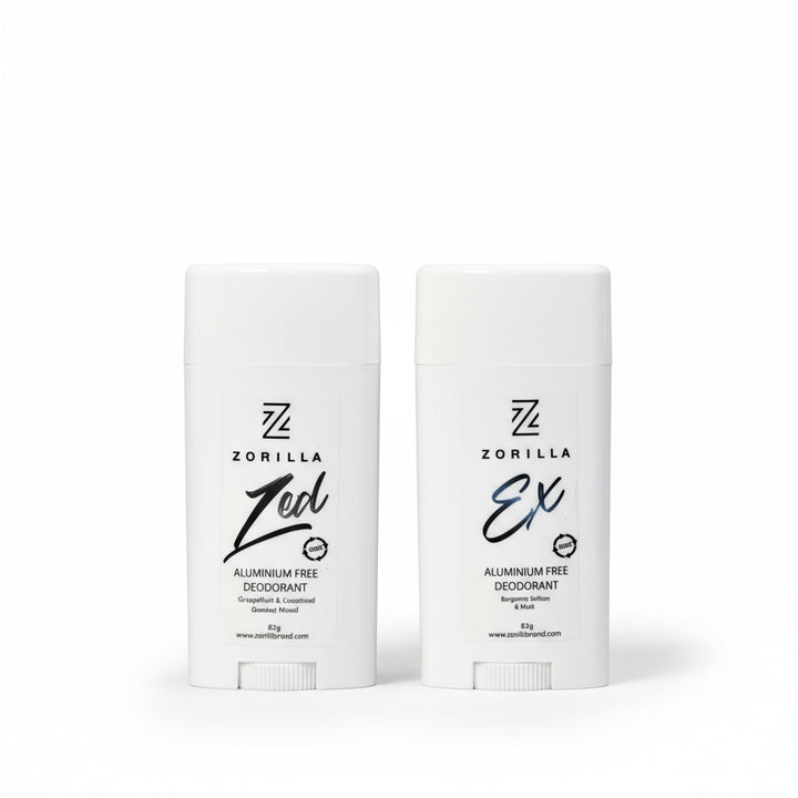 Two stick deodorants, one labeled 'Zed' and the other 'Ex', from the Zorilla brand, placed upright on a textured surface.