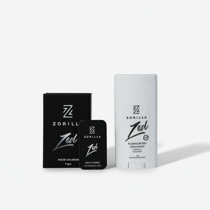 A product image featuring a white stick deodorant and a black bottle of cologne, both with 'Zorilla' branding and 'Zed' cologne reference. Presented on a marble background.